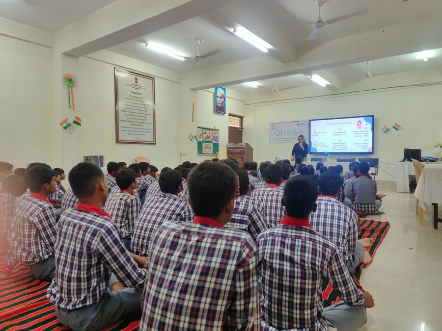 Students watching a slide titled Understanding Anger